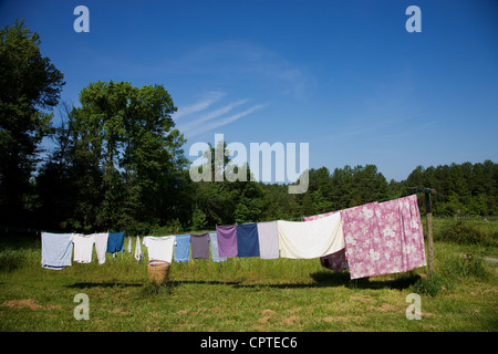 Clothes hanging on washing line in field Stock Photo