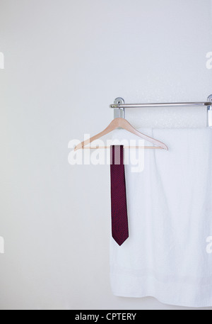 Tie on clothes hanger in hotel bathroom Stock Photo