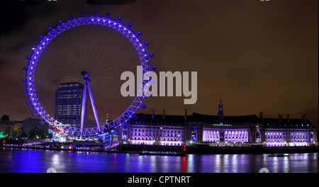 The London Eye and the old County Hall lit up at night Stock Photo