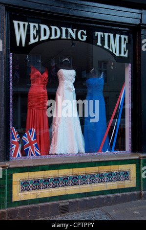 The window of a patriotic wedding outfitters, with red, white, and blue bridal gowns on display. The Queen's Diamond Jubilee. England, United Kingdom. Stock Photo