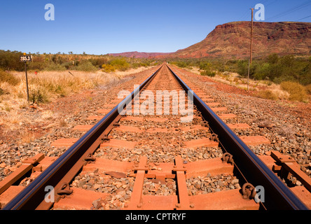 Railway line running beside Mount Nameless near the town of Tom Price in Western Australia. Stock Photo