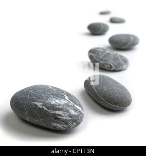 Snaking line of black and grey pebbles. Stock Photo