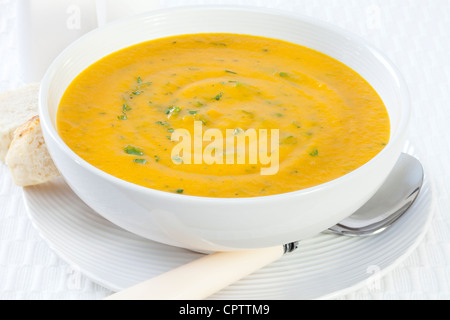 A bowl of beautiful, healthy, orange carrot soup, flavoured with sherry and coriander. Could also be pumpkin soup. Stock Photo