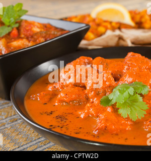Favourite Indian curry Rogan Josh with chapatis and channa dhal, and chicken jalfrezi. Stock Photo