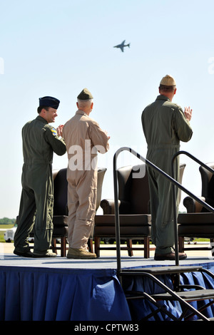 Col Kenneth Rizer, Commander, 11th Wing/Joint Base Andrews, Commandant of Marine Corps Gen. James F. Amos and Navy Captain Randy Johnson, Navy Air Facility Washington commander, watch a Marine Corps AV-8B Harrier fly by during the opening ceremony of 2012 Joint Service Open House, May 19 at Joint Base Andrews, Md. This year's Joint Service Open House celebrates the Centennial of Marine Corps Aviation. JSOH affords the public and opportunity to meet the men and women of the Armed Forces while viewing more than 100 static displays and 19 aerial demonstration teams. Stock Photo