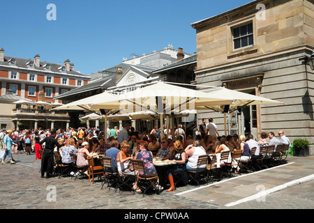 Customers at cafe outdoor tables, Covent Garden Piazza, London, UK Stock Photo