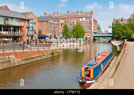 Barge or Narrow boat moored on the Nottingham canal and converted warehouses in the city centre Nottingham England UK GB EU Stock Photo