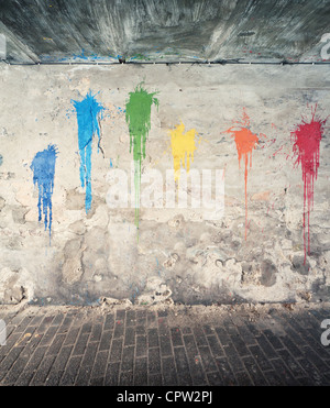 Aged street wall background with colorful paint splashes Stock Photo