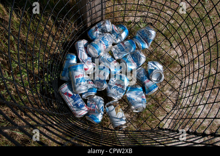 Empty beer cans in a wire waste basket Stock Photo