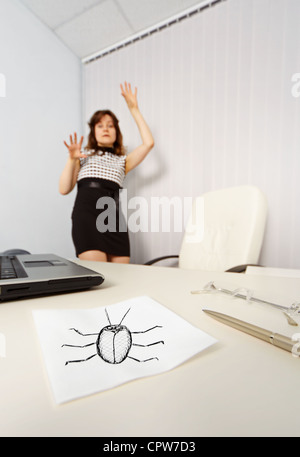 The woman was frightened drawn cockroach in the office Stock Photo