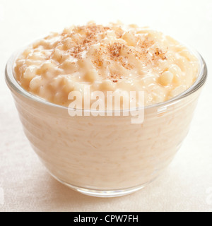 Rice pudding sprinkled with nutmeg in an individual glass bowl. Stock Photo