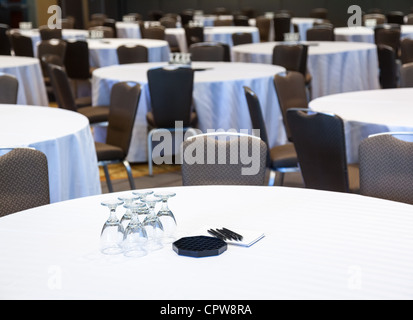 Empty conference room with many tables with white cloths Stock Photo