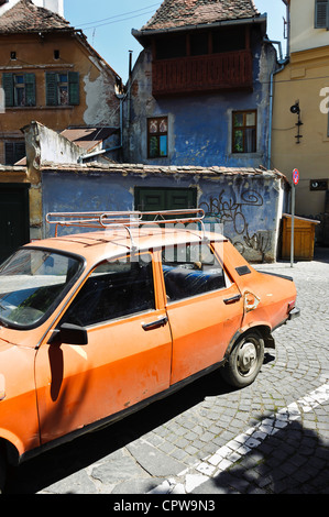 Old orange car Sibiu, Transylvania, Romania Stock Photo - Alamy