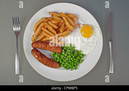 Sausage, egg, chips and peas Stock Photo