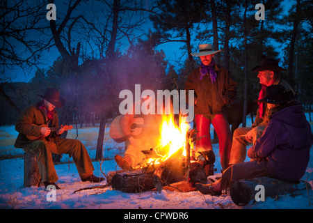 Cowboys and cowgirl around a campfire on a ranch in northeastern Wyoming Stock Photo