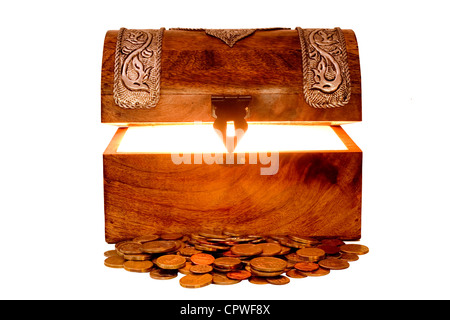 Glowing treasure chest with lid lifted and with a pile of coins in front of it, isolated on white. Stock Photo