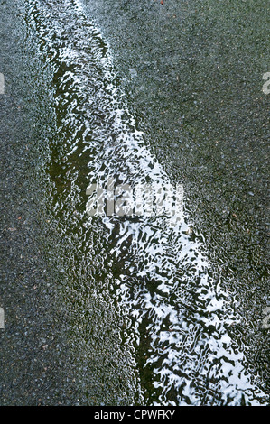 Water running down alleyway - France. Stock Photo
