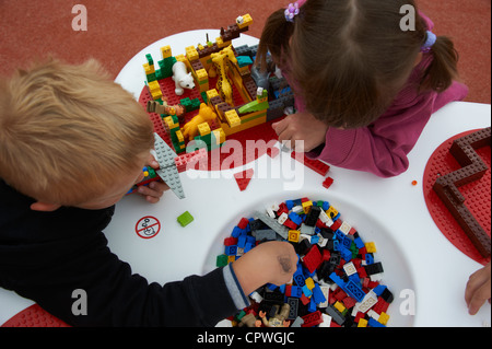 Children boy and girl playing with building bricks Stock Photo