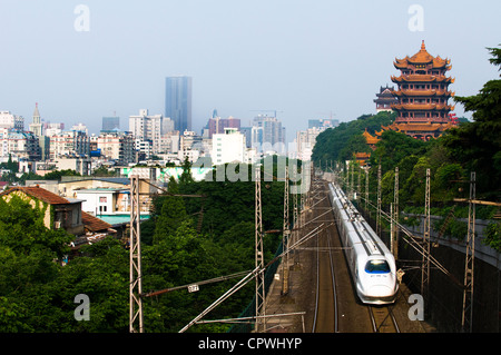 A CRH bullet train passing by the Yellow crane pagoda in Wuhan, China. Stock Photo