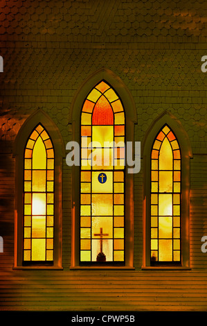 Illuminated church windows at night. Stock Photo