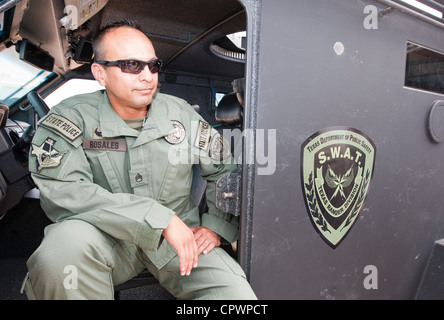 male member of the Texas Department of Public Safety SWAT Team, division Texas Rangers sits in armored vehicle during exercise Stock Photo