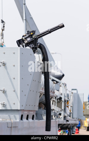 Water cooled gatling machine gun mounted on the side of HMS Bangor Stock Photo