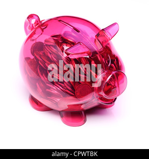 Transparent pink plastic piggy bank full of coins Stock Photo