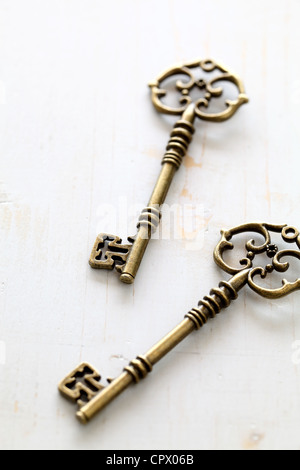 Antique keys on white table Stock Photo