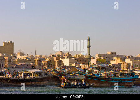 Ferry boats and skyline along Khor Dubai (Dubai Creek), Dubai, United Arab Emirates Stock Photo
