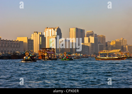 Ferry boats and skyline along Khor Dubai (Dubai Creek), Dubai, United Arab Emirates Stock Photo