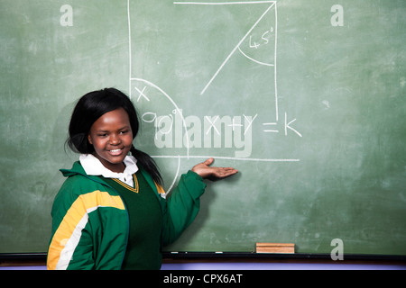 A young girl solving a math sum on a blackboard, Meyerton Primary School, Meyerton, Gauteng Stock Photo