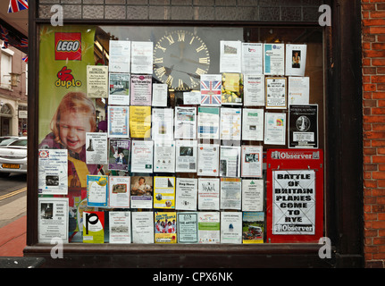 Shop window covered in notices. Stock Photo