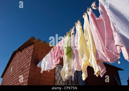 Closeup of a washing line hanging from the side of a house Stock Photo