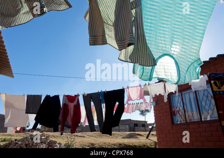 Washing lines hanging from the side of a house Stock Photo