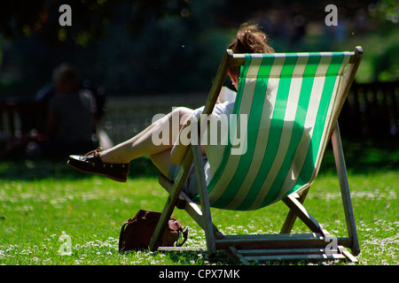 Woman relaxing on a Sunny day at St James's Park, London Stock Photo