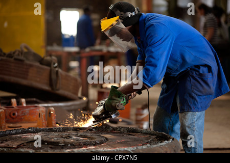 Grinding an industrial magnet in a magnet factory, Gauteng, South Africa Stock Photo