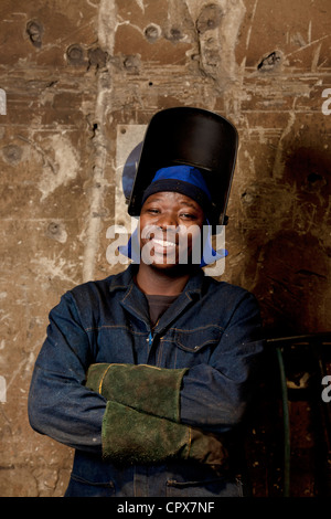 Factory worker posing in welding helmet, magnet factory, Gauteng, South Africa Stock Photo