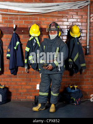 A fireman putting on his gear & clothing Stock Photo