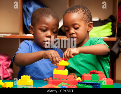 Two children playing with lego Stock Photo