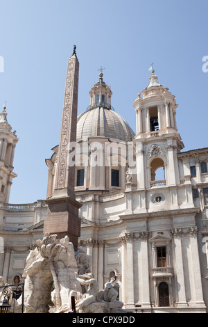 The 'Obelisk of Domitian' standing before the church of 'Sant'Agnese in Agone' a Baroque church in Piazza Navona, Rome, Italy. Stock Photo