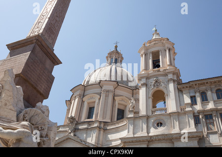 The 'Obelisk of Domitian' standing before the church of 'Sant'Agnese in Agone' a Baroque church in Piazza Navona, Rome, Italy. Stock Photo