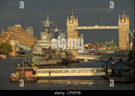 HMS Belfast floating museum with Tower Bridge in the background on the river Thames in London, England. Stock Photo