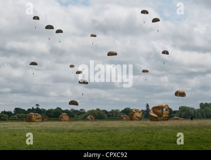 Task Force 68, which is made up of paratroopers from U.S., Germany, France, Holland, and United Kingdom, re-enacted the D-Day airborne operation on the La Fiere fields near Ste. Mere Eglise, France to commemorate the heroic acts of the WWII paratroopers who made the jump 68 years ago. After the jump, the task force marched into the town of Ste. Mere Eglise tothe sounds of cheers from the locals. Task Force 68 is in Normandy, France to commemorate the 68th annivesary of D-Day. Stock Photo