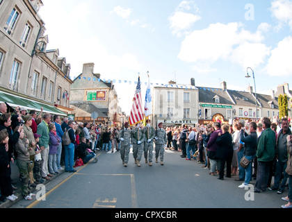 Task Force 68, which is made up of paratroopers from U.S., Germany, France, Holland, and United Kingdom, re-enacted the D-Day airborne operation on the La Fiere fields near Ste. Mere Eglise, France to commemorate the heroic acts of the WWII paratroopers who made the jump 68 years ago. After the jump, the task force marched into the town of Ste. Mere Eglise tothe sounds of cheers from the locals. Task Force 68 is in Normandy, France to commemorate the 68th annivesary of D-Day. Stock Photo