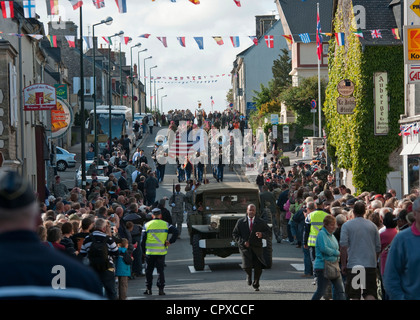 Task Force 68, which is made up of paratroopers from U.S., Germany, France, Holland, and United Kingdom, re-enacted the D-Day airborne operation on the La Fiere fields near Ste. Mere Eglise, France to commemorate the heroic acts of the WWII paratroopers who made the jump 68 years ago. After the jump, the task force marched into the town of Ste. Mere Eglise tothe sounds of cheers from the locals. Task Force 68 is in Normandy, France to commemorate the 68th annivesary of D-Day. Stock Photo