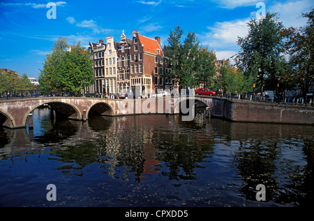 Netherlands, Amsterdam, stone bridge at corner of Prinsengracht and Leidsegracht canals in downtown Stock Photo