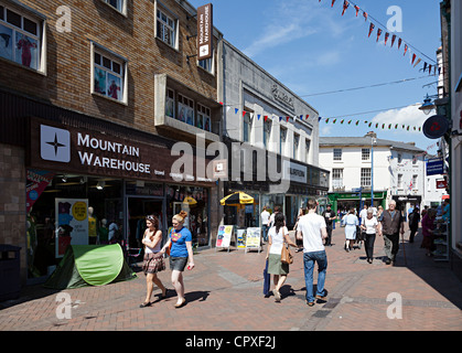 People walking through pedestrianised section of main shopping street, Abergavenny, Wales, UK Stock Photo