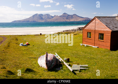 A house at Laig Bay on the Isle of Eigg, looking towards the Isle of Rhum, Scotland, UK. Stock Photo