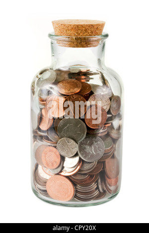 Glass bottle full of coins on white Stock Photo