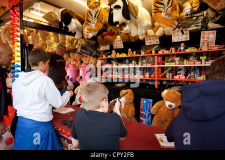 Shooting games on a side stall at a British Fairground. Stock Photo